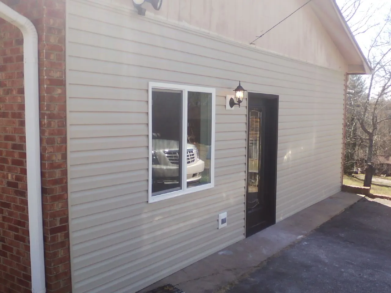 New vinyl siding and entry door on a room addition in Columbia